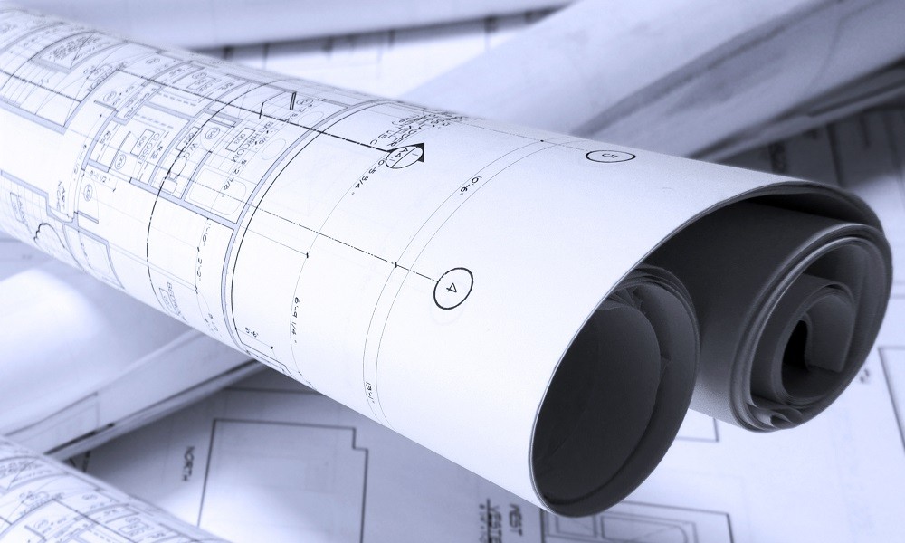 roled -up plans on the table